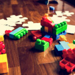 9 great gifts to inspire kindness and caring kid toys on wooden floor pew6v5y